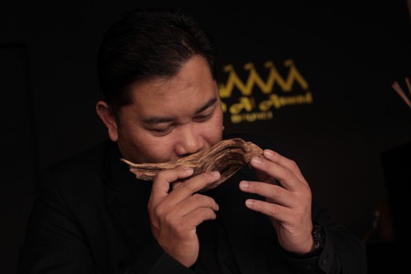 Hj Raduan taking a whiff off a bark of agarwood - said to be the most expensive timber in the world