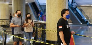 Government introduces sector guidelines, fines for transition phase People entering premise during second wave