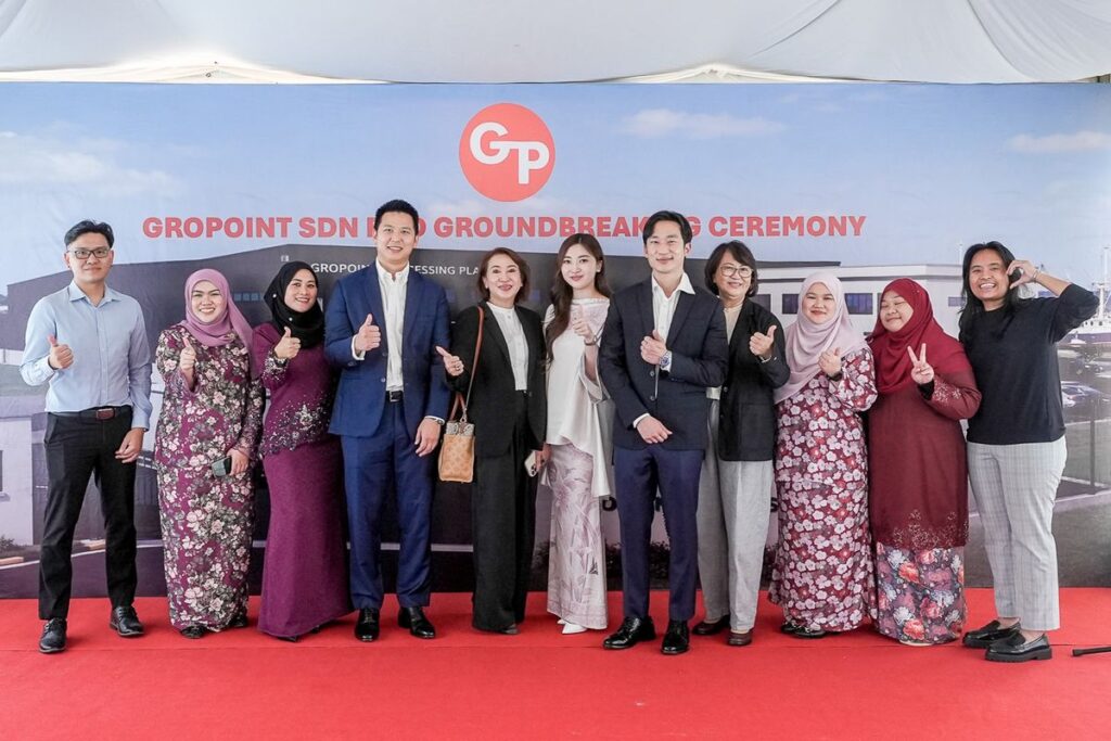 Gropoint Managing Director Wei Lee, CEO Eileen Lee, their mother and members of the Gropoint team behind the company’s seafood processing facility in Serasa, Brunei.